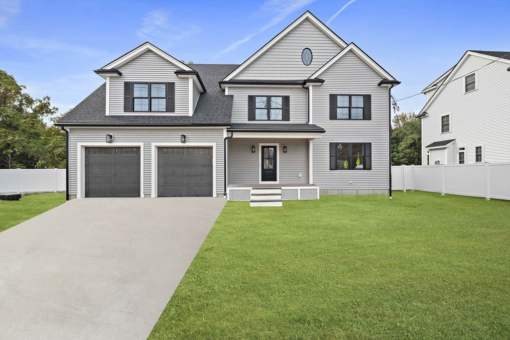185 Lexington Street Woburn, MA 01801 - Photo 1 of 39 a front view of a house with a yard and garage