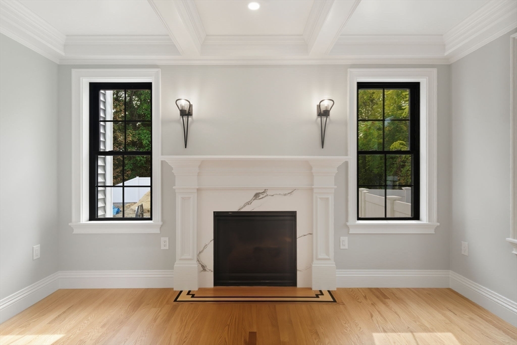 185 Lexington Street Woburn, MA 01801 - Photo 12 of 39 a living room with a fireplace and a window