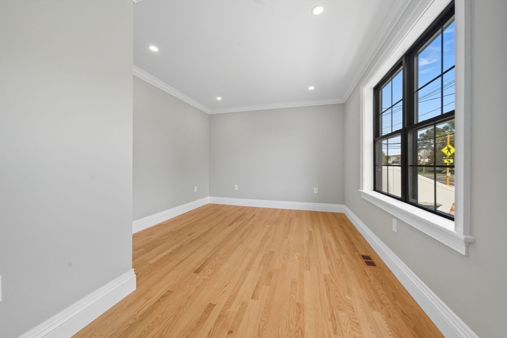 185 Lexington Street Woburn, MA 01801 - Photo 16 of 39 a view of empty room with wooden floor and fan