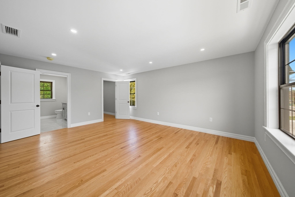 185 Lexington Street Woburn, MA 01801 - Photo 18 of 39 an empty room with wooden floor and windows