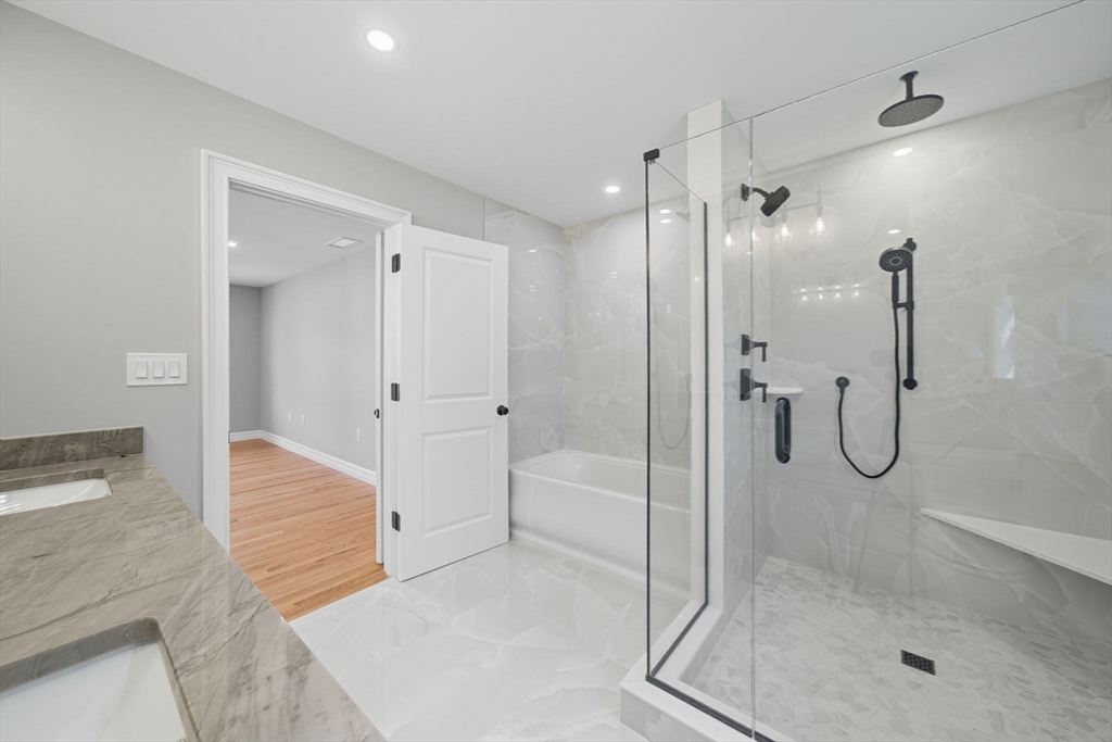 185 Lexington Street Woburn, MA 01801 - Photo 21 of 39 a bathroom with a glass shower door and a sink