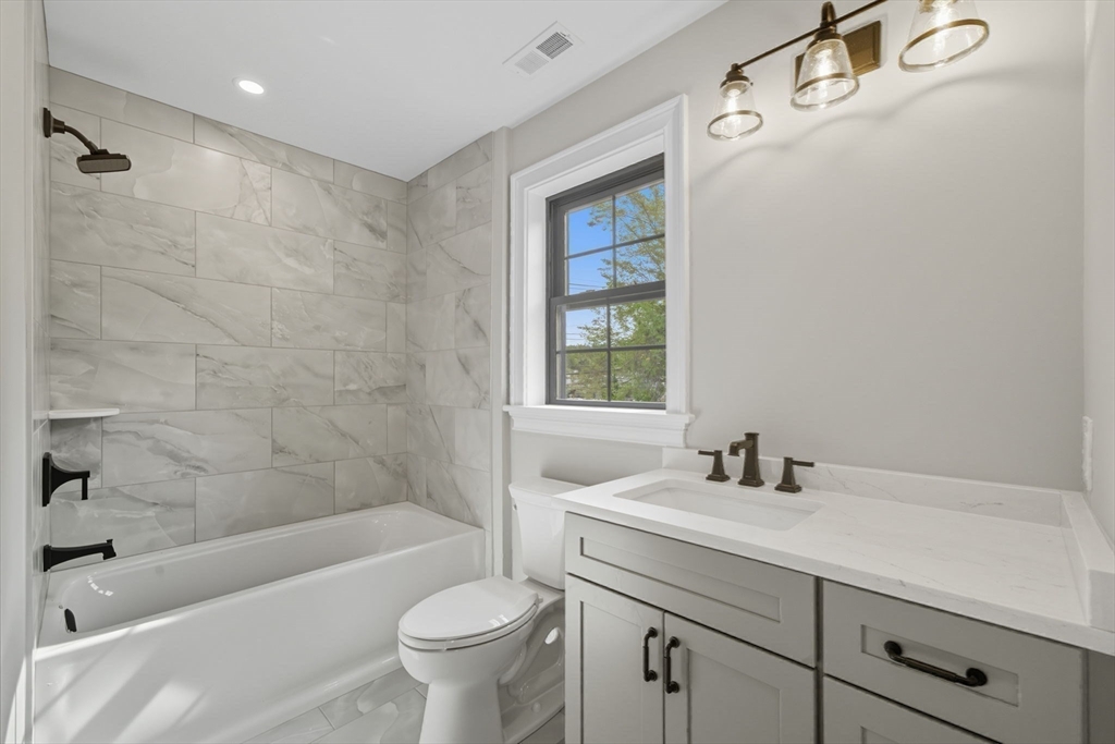 185 Lexington Street Woburn, MA 01801 - Photo 23 of 39 a bathroom with a sink mirror toilet and bathtub