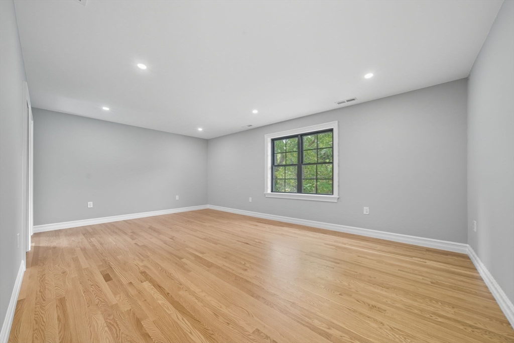 185 Lexington Street Woburn, MA 01801 - Photo 25 of 39 a view of an empty room with wooden floor and a window