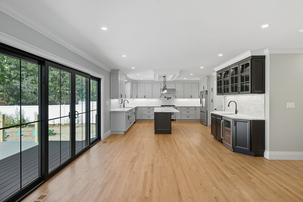 185 Lexington Street Woburn, MA 01801 - Photo 4 of 39 a large white kitchen with a large window and stainless steel appliances