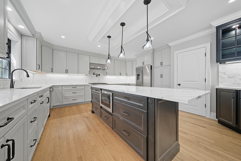 185 Lexington Street Woburn, MA 01801 - Photo 6 of 39 a large kitchen with stainless steel appliances sink a microwave and cabinets