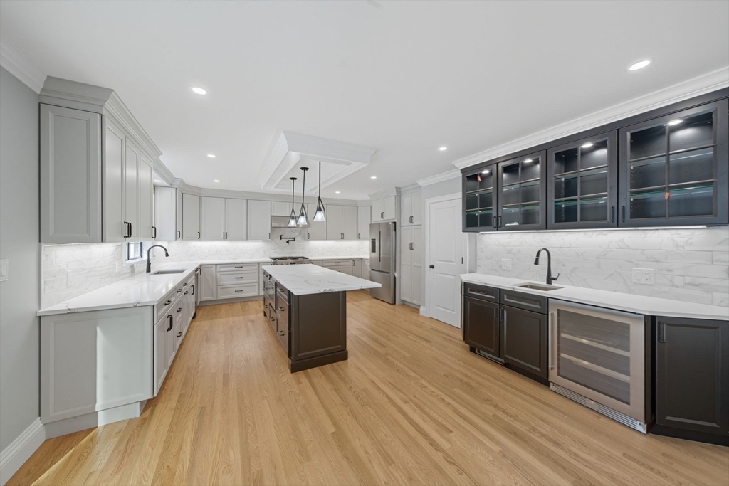 185 Lexington Street Woburn, MA 01801 - Photo 7 of 39 a large kitchen with stainless steel appliances a lot of counter space and a sink