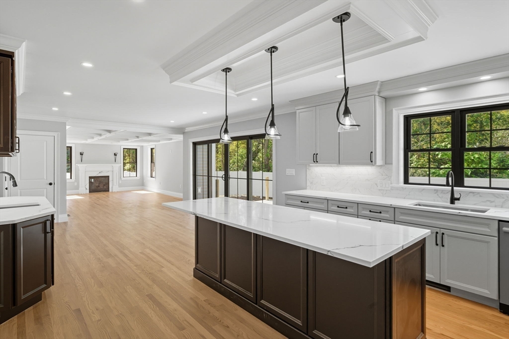 185 Lexington Street Woburn, MA 01801 - Photo 8 of 39 a kitchen with a sink stove and wooden floor