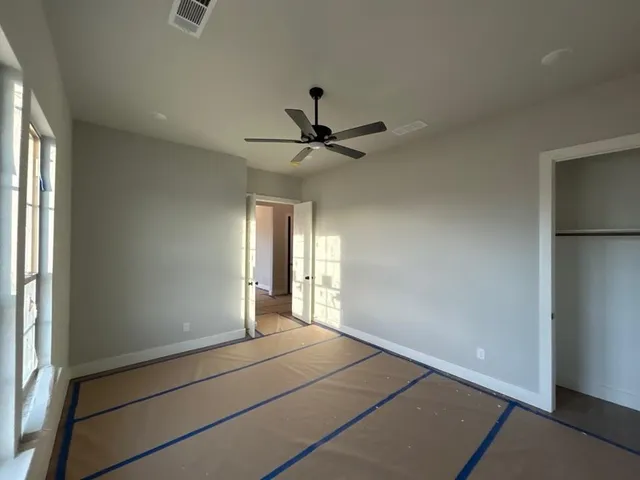 a view of a livingroom with a ceiling fan and window