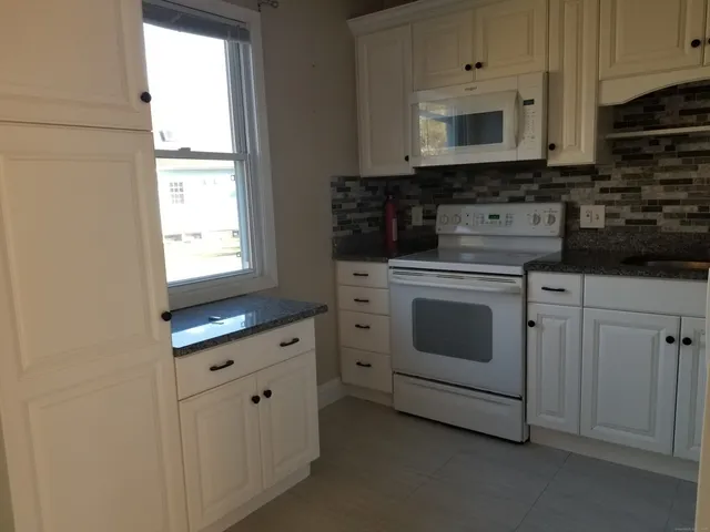 a bathroom with a sink toilet and mirror