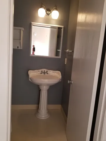 a white toilet sitting next to a white sink