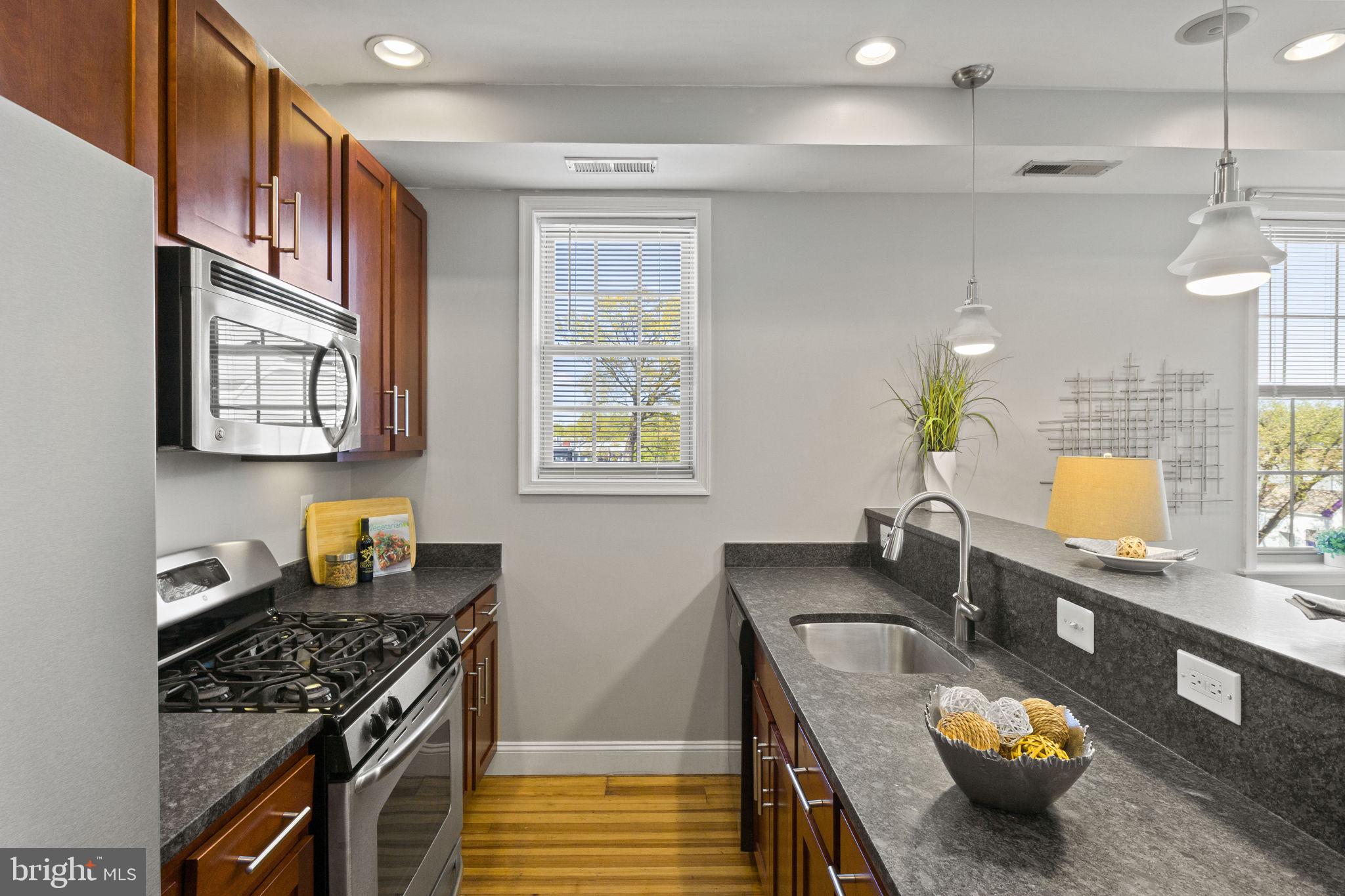 410 15th Street Northeast, Unit 22 Washington, DC 20002 - Photo 5 of 27 a kitchen with furniture and a stove