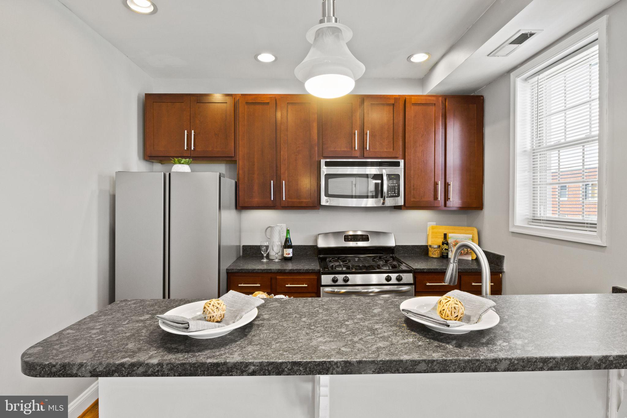 410 15th Street Northeast, Unit 22 Washington, DC 20002 - Photo 6 of 27 a kitchen with furniture and a wooden floor