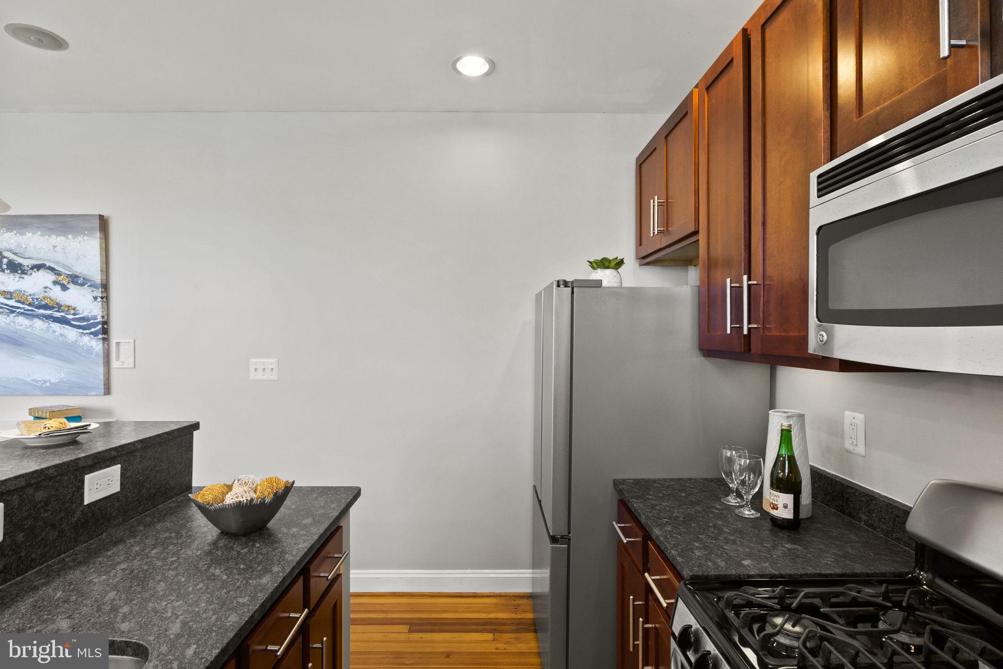 410 15th Street Northeast, Unit 22 Washington, DC 20002 - Photo 7 of 27 a kitchen with stainless steel appliances granite countertop a sink and a refrigerator