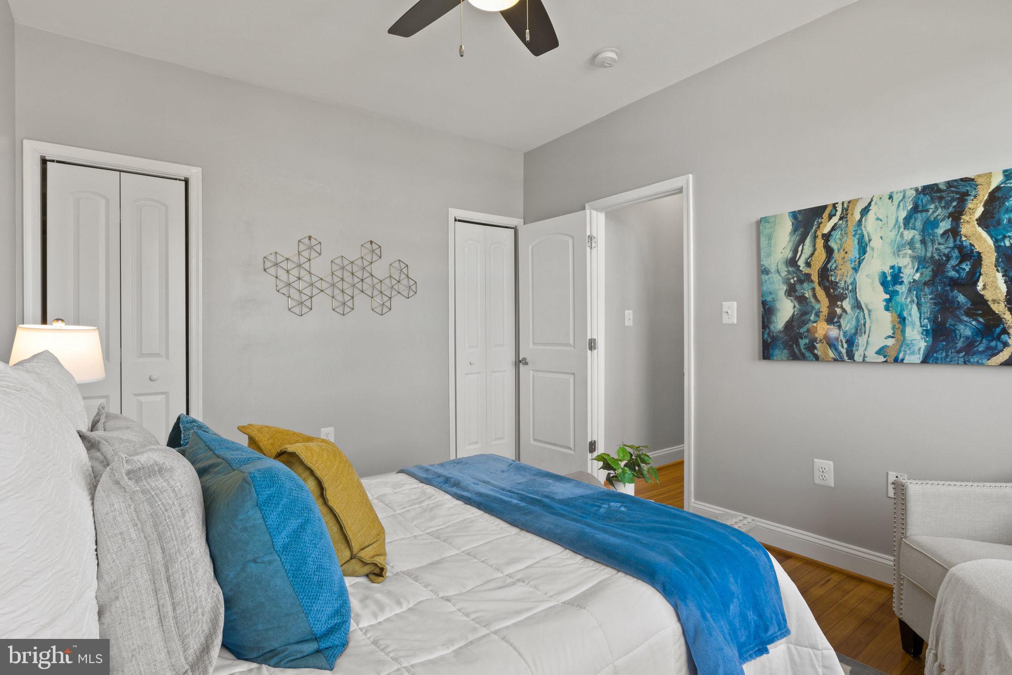 410 15th Street Northeast, Unit 22 Washington, DC 20002 - Photo 9 of 27 a bedroom with a bed and a painting on the wall