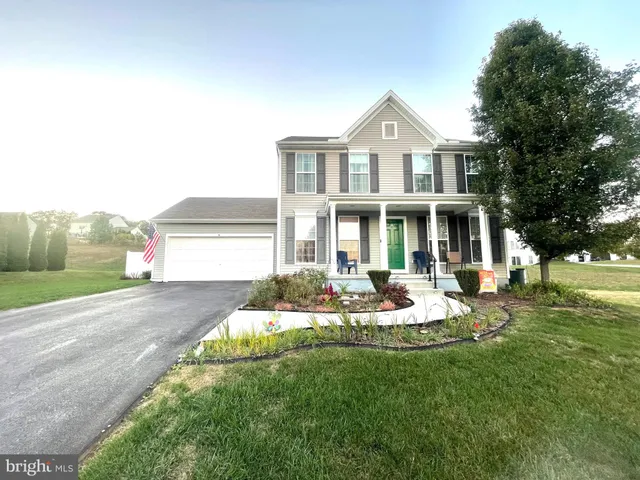 a front view of a house with a yard table and chairs