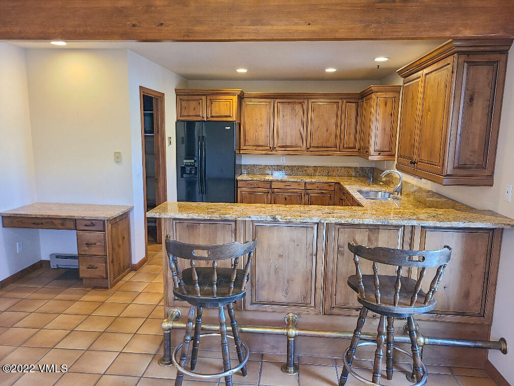753 Bull Run Eagle, CO 81631 - Photo 8 of 30 a kitchen with a table chairs and a refrigerator