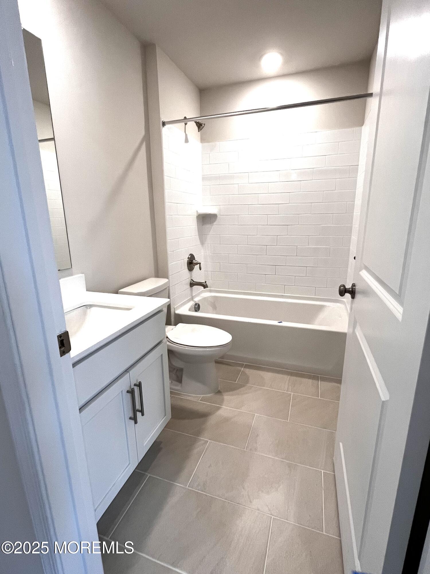 16 Rothbury Court Tinton Falls, NJ 07753 - Photo 14 of 28 a bathroom with a sink a toilet and shower