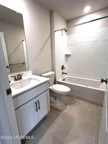 a bathroom with a double vanity sink toilet and shower