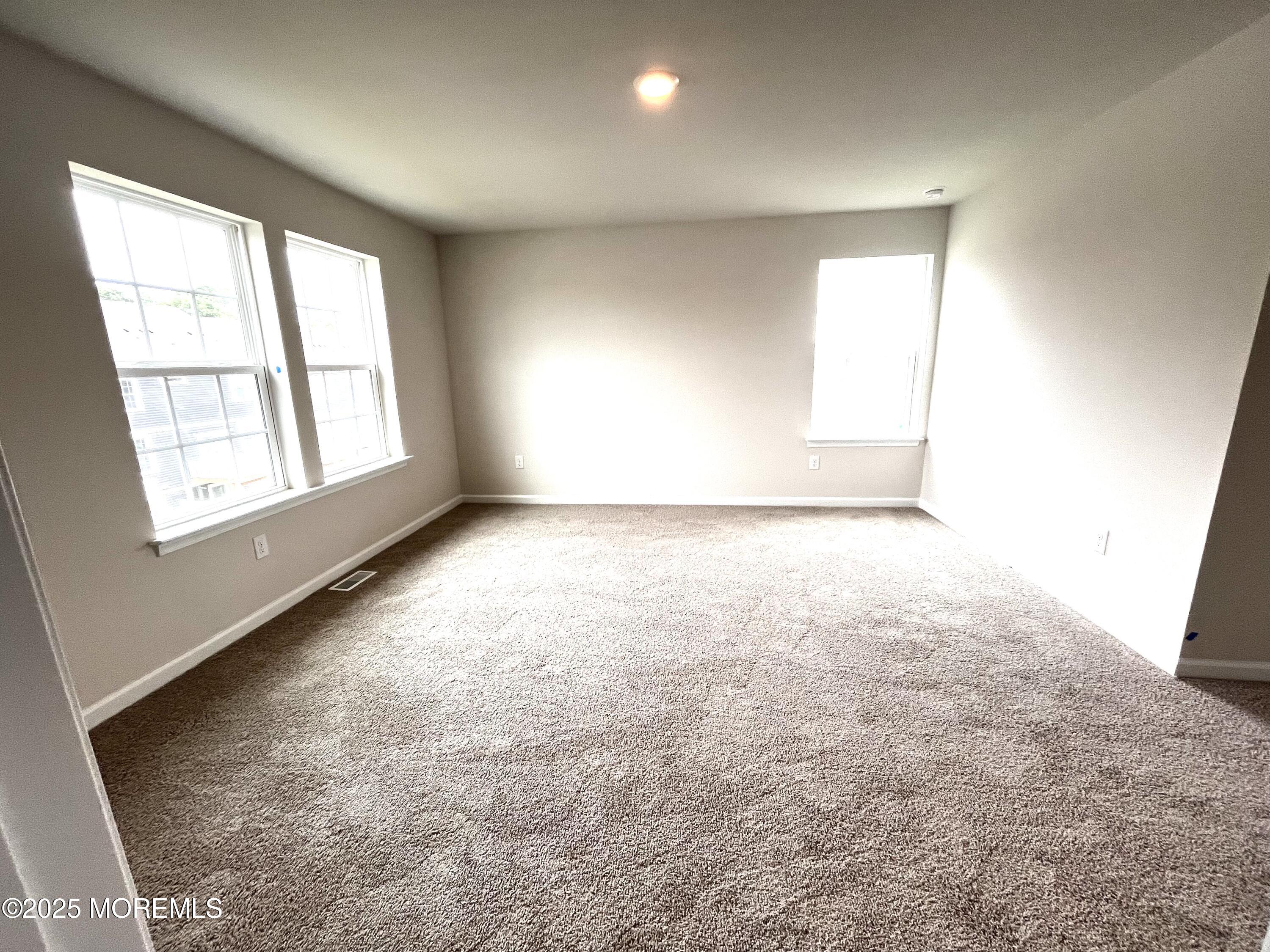 16 Rothbury Court Tinton Falls, NJ 07753 - Photo 8 of 28 an empty room with windows