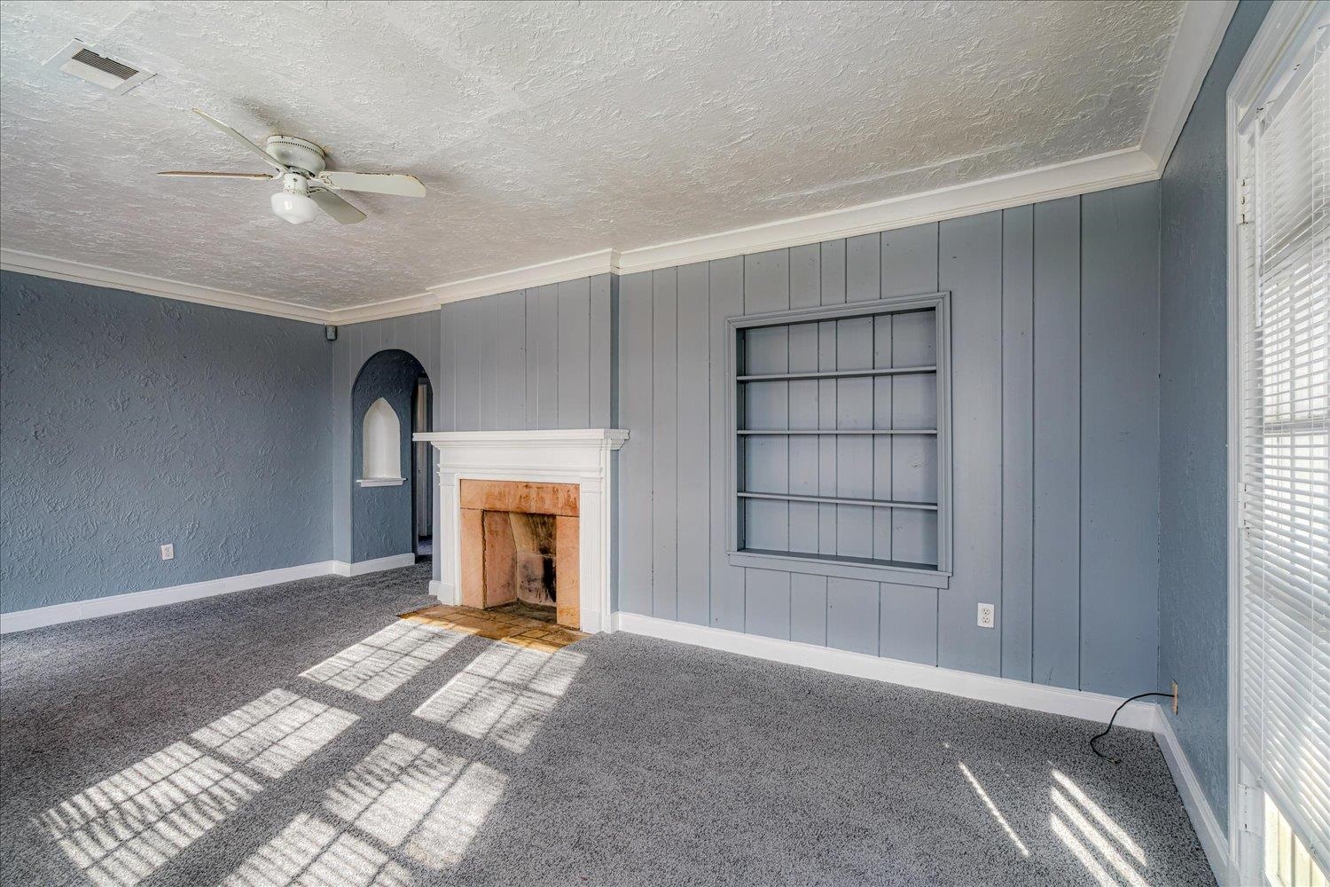 1114 Brownlee Road Memphis, TN 38116 - Photo 11 of 32 a view of an empty room with a fireplace and a window