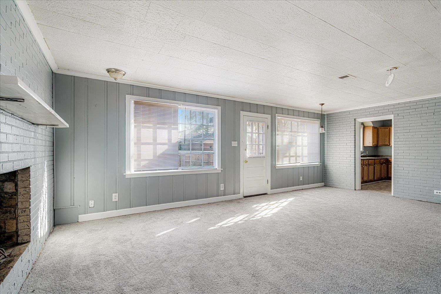 1114 Brownlee Road Memphis, TN 38116 - Photo 17 of 32 an empty room with windows and fireplace