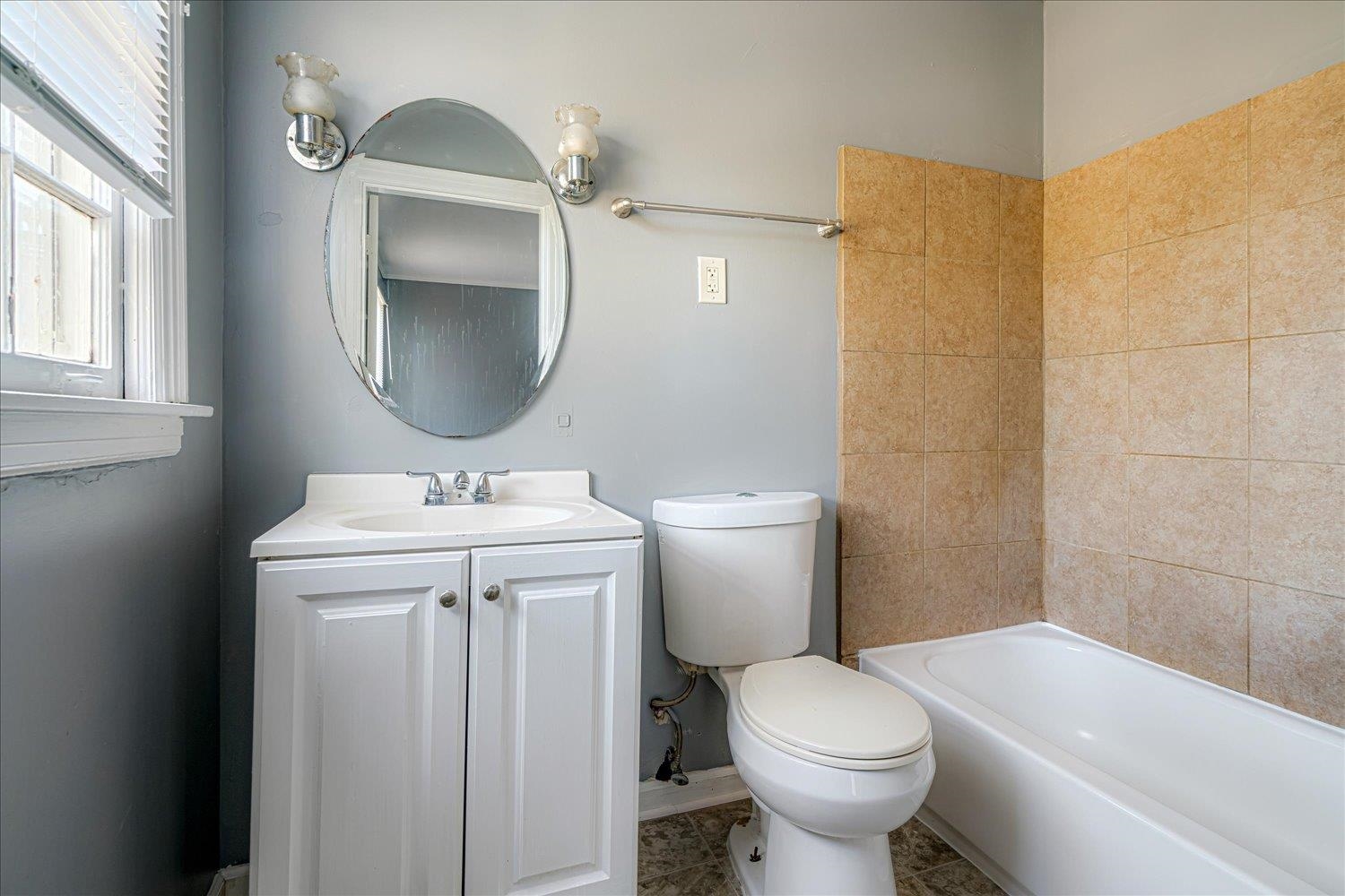 1114 Brownlee Road Memphis, TN 38116 - Photo 27 of 32 a bathroom with a sink toilet and mirror