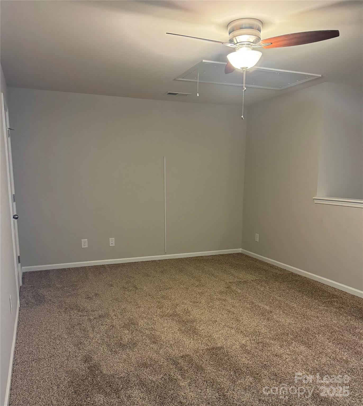 18431 The Commons Boulevard Cornelius, NC 28031 - Photo 15 of 24 a view of an empty room with a fan