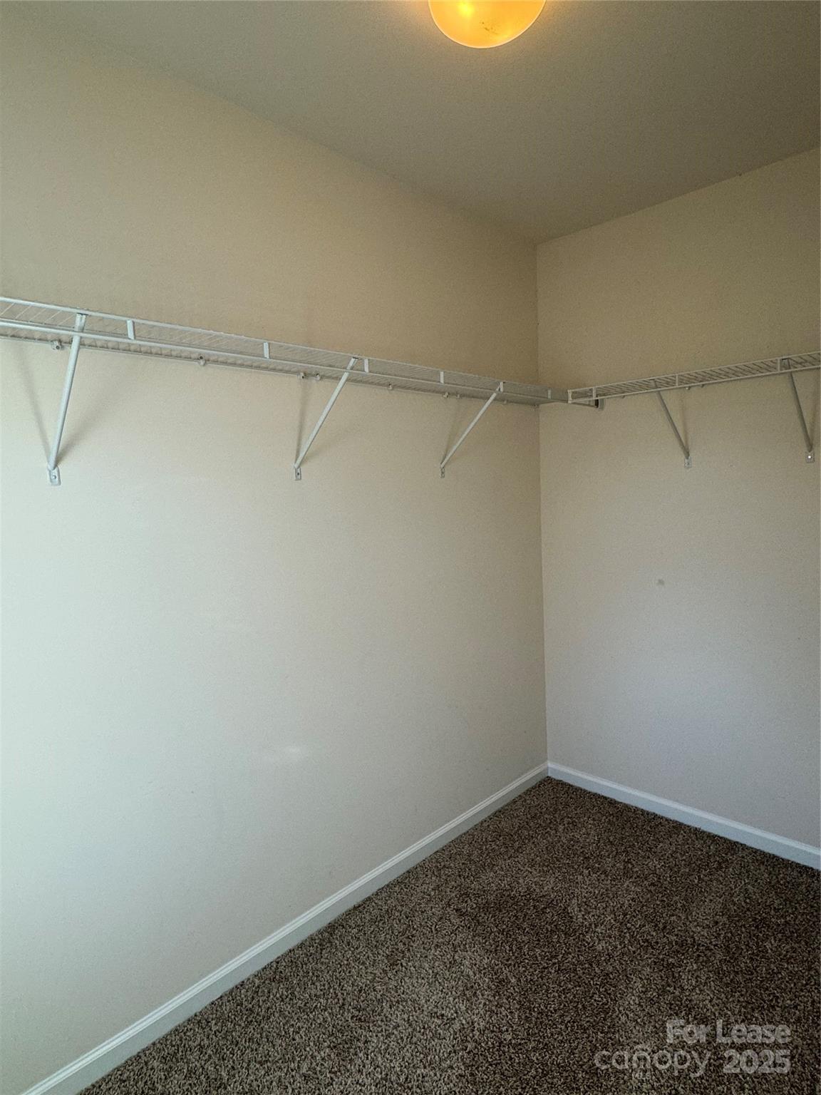 18431 The Commons Boulevard Cornelius, NC 28031 - Photo 19 of 24 a view of a room with racks on the wall