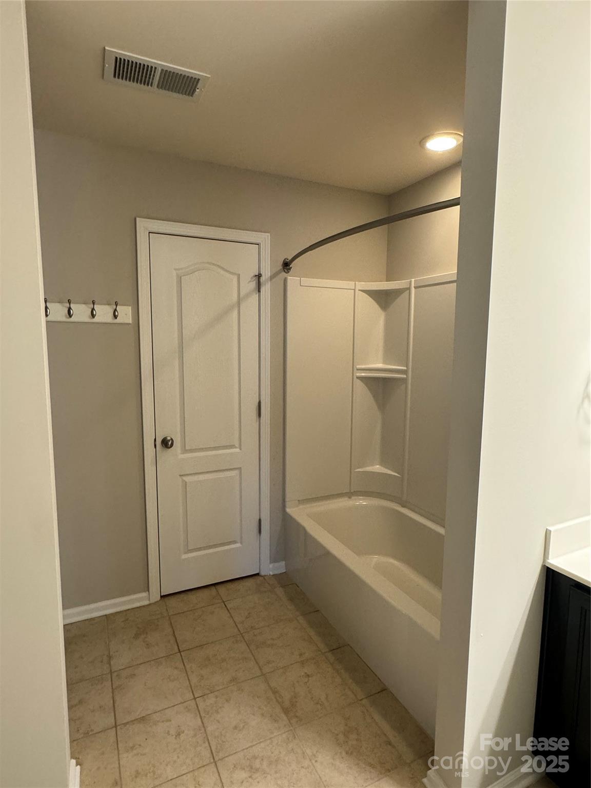 18431 The Commons Boulevard Cornelius, NC 28031 - Photo 22 of 24 a bathroom with a bathtub and a shower