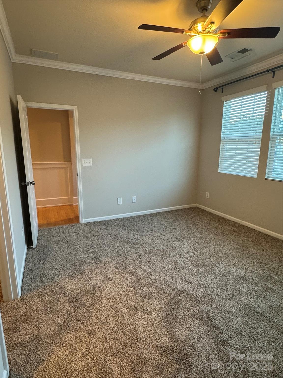 18431 The Commons Boulevard Cornelius, NC 28031 - Photo 9 of 24 an empty room with windows and fan