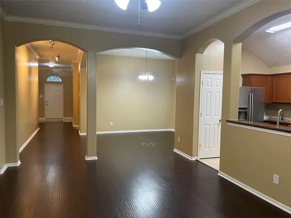 a view of a room with wooden floor and a window