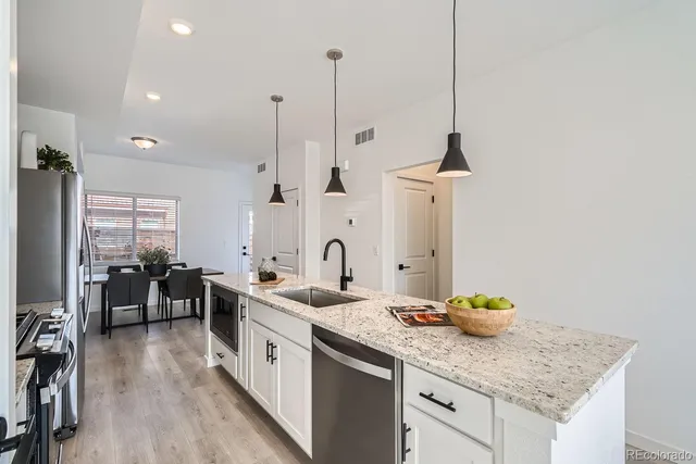 a kitchen with sink stove and cabinets