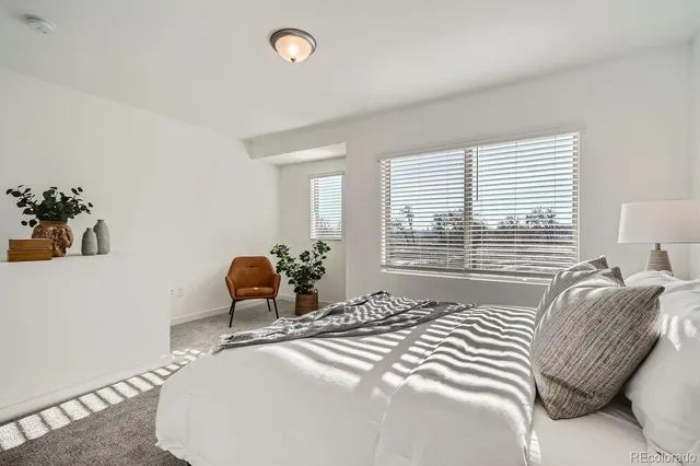 a bedroom with a bed and a chair