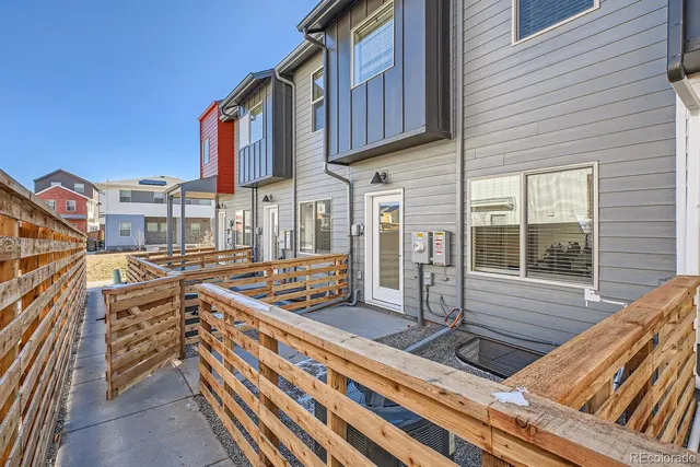 a view of a house with pool and wooden fence