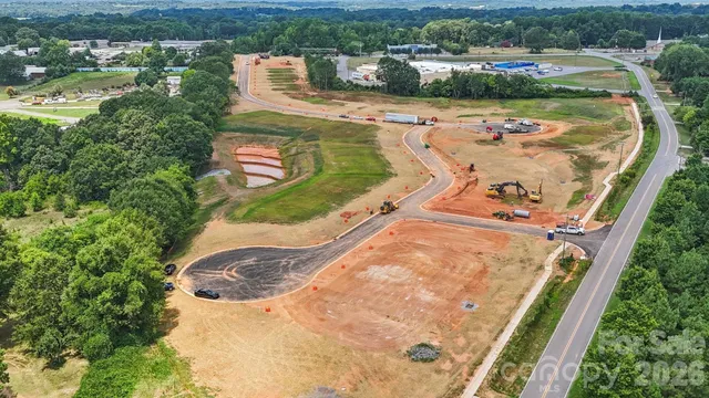 an aerial view of a house with a yard and lake view