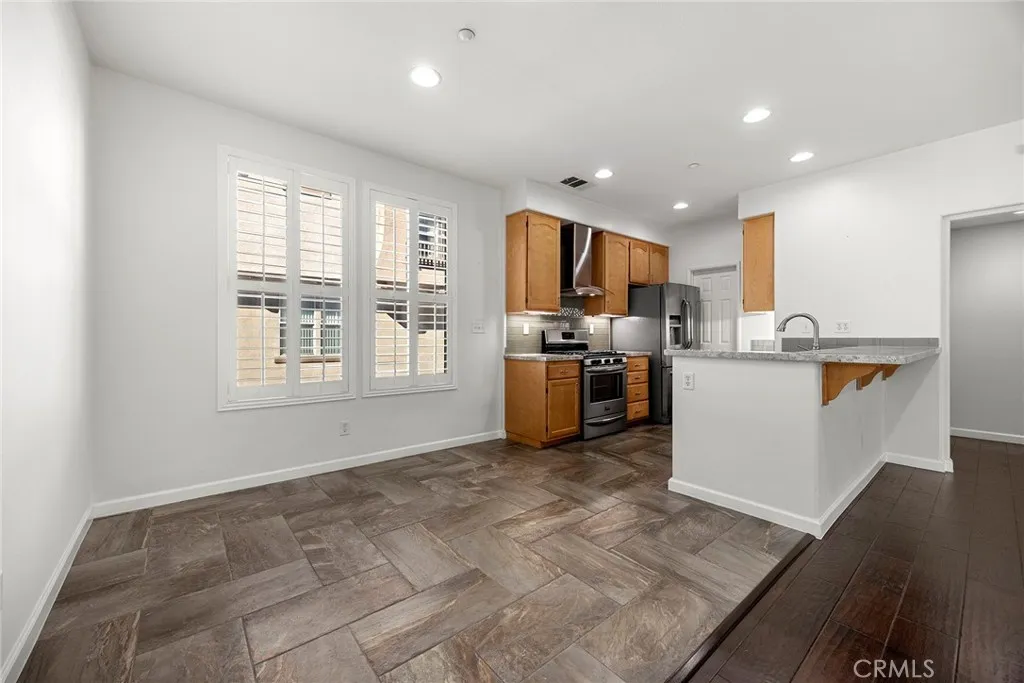 748 Ashby Lane, Unit 55 Brea, CA 92821 - Photo 12 of 41 a kitchen with stainless steel appliances granite countertop a refrigerator sink and microwave