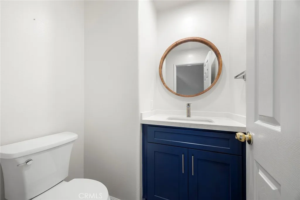 748 Ashby Lane, Unit 55 Brea, CA 92821 - Photo 14 of 41 a bathroom with a toilet a sink and mirror