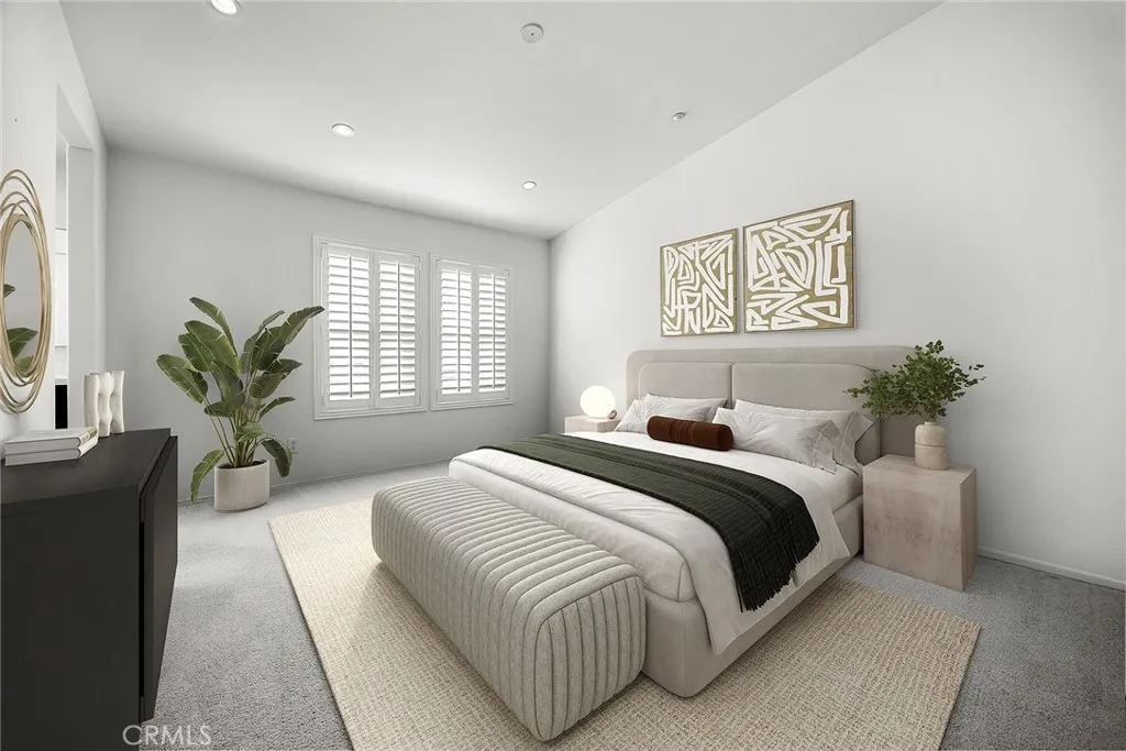 748 Ashby Lane, Unit 55 Brea, CA 92821 - Photo 17 of 41 a spacious bedroom with a large bed couch and a potted plant