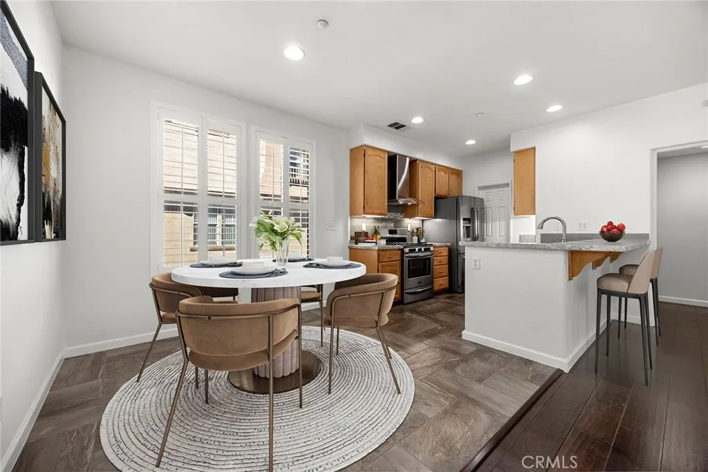 748 Ashby Lane, Unit 55 Brea, CA 92821 - Photo 2 of 41 a dining room with kitchen island a table and chairs