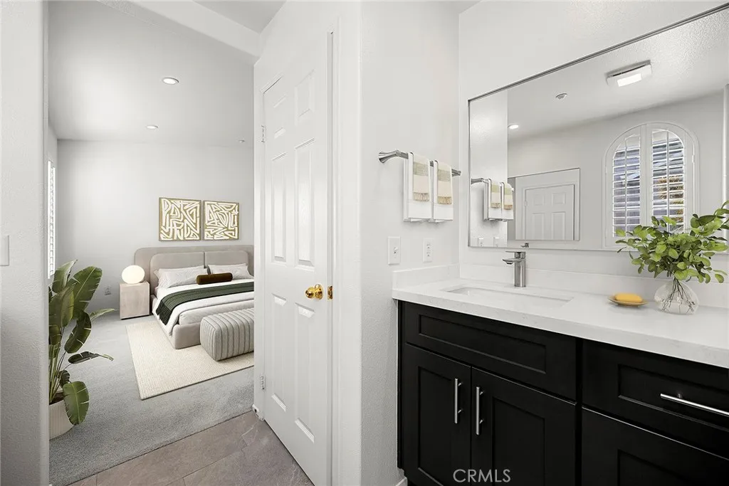 748 Ashby Lane, Unit 55 Brea, CA 92821 - Photo 29 of 41 a en suite bathroom with a granite countertop sink and mirror