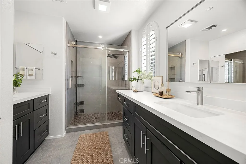 748 Ashby Lane, Unit 55 Brea, CA 92821 - Photo 33 of 41 a spacious bathroom with a shower sink and mirror