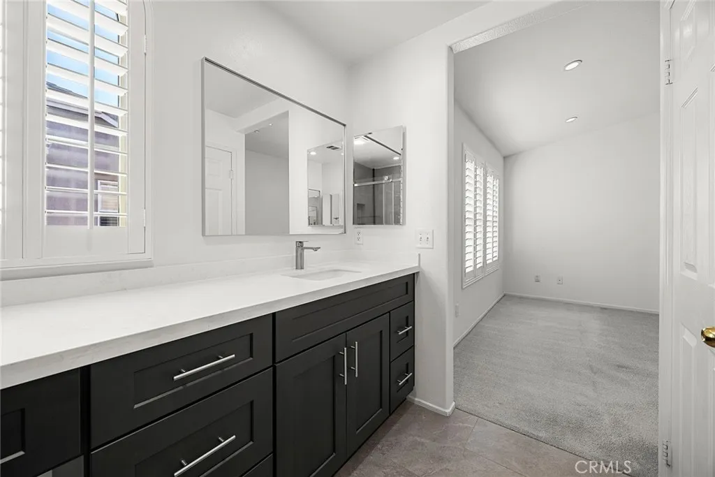 748 Ashby Lane, Unit 55 Brea, CA 92821 - Photo 34 of 41 a spacious bathroom with a double vanity sink a mirror and a bathtub