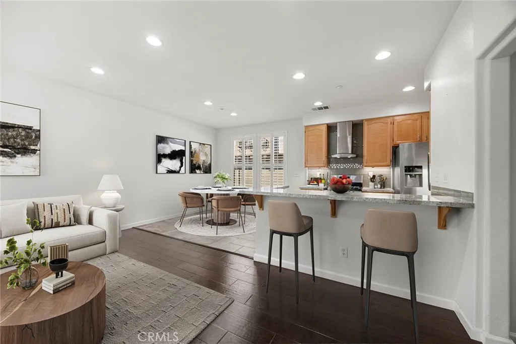 748 Ashby Lane, Unit 55 Brea, CA 92821 - Photo 4 of 41 a living room with furniture and a dining table with kitchen view