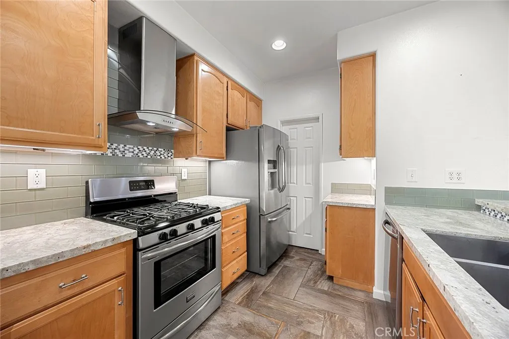 748 Ashby Lane, Unit 55 Brea, CA 92821 - Photo 10 of 41 a kitchen with a stove a refrigerator and a sink