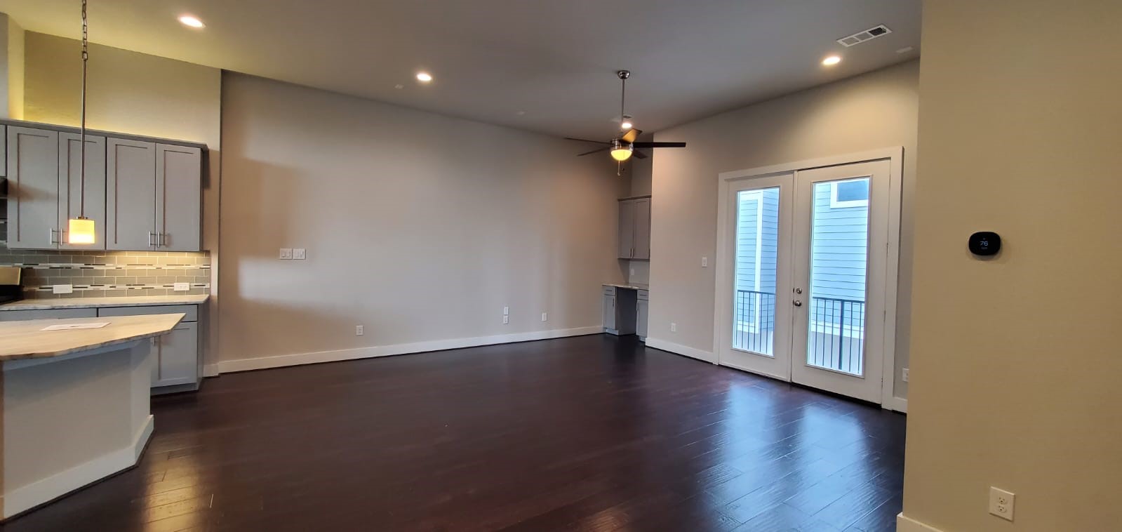 2422 Maufferd Street Houston, TX 77009 - Photo 11 of 35 an empty room with wooden floor and a kitchen