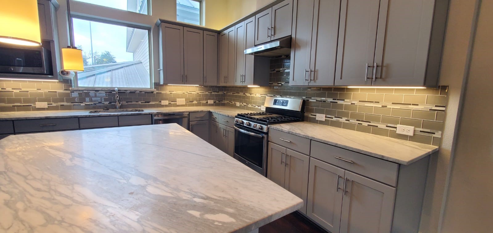 2422 Maufferd Street Houston, TX 77009 - Photo 13 of 35 a kitchen with stainless steel appliances granite countertop a sink stove and microwave