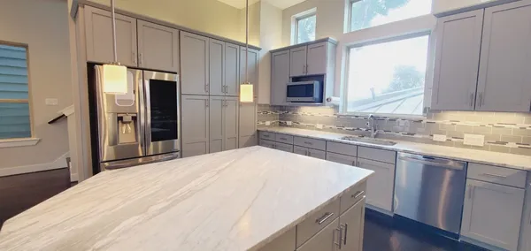 a bedroom with a large bed couch and a large window