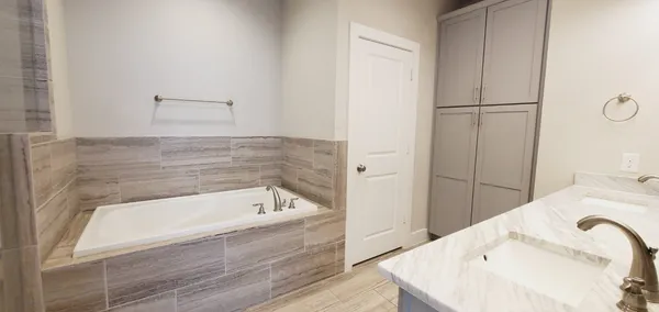 a bathroom with a bathtub and a shower