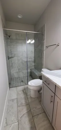 a bathroom with a shower and a toilet