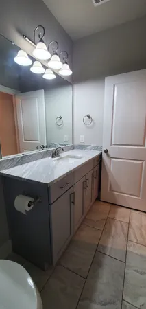 a bathroom with a sink a vanity and mirror